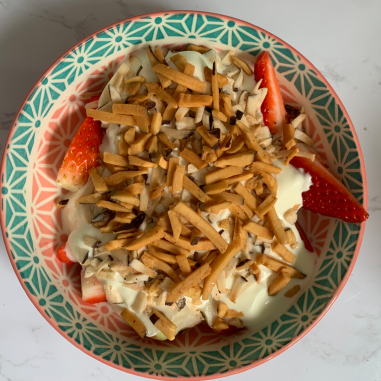 Caramelised Gocojoy coconut shards sprinkled on greek yoghurt and fresh strawberries